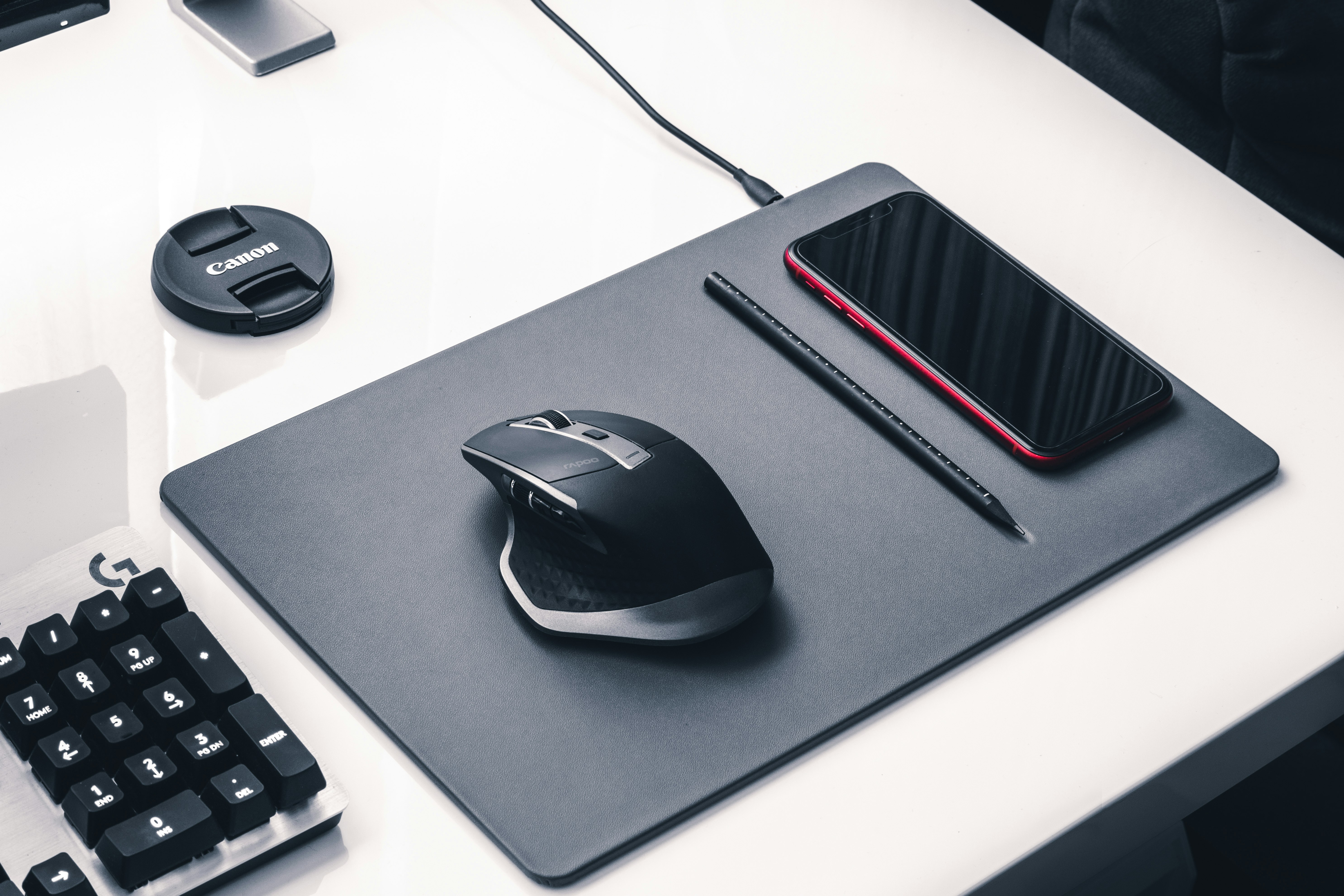 black and gray corded computer mouse on black mouse pad